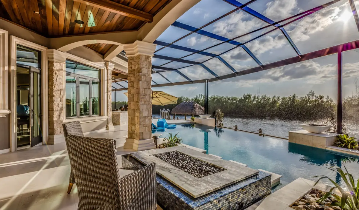 A patio with a fire pit and chairs in it