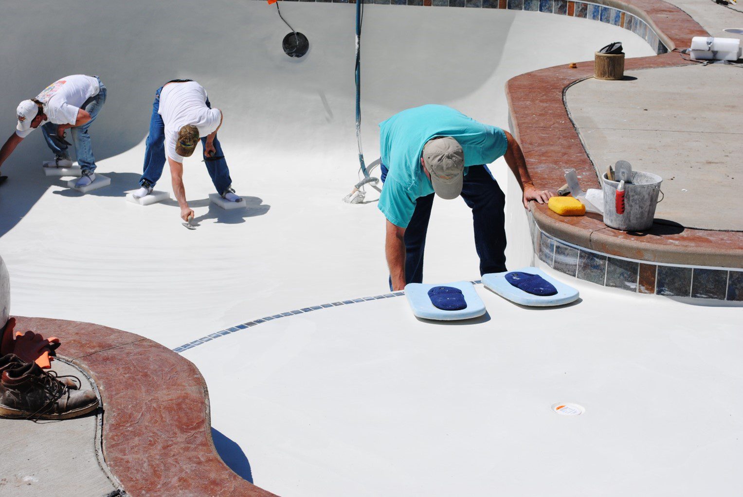 Two people are working on a skateboard ramp.