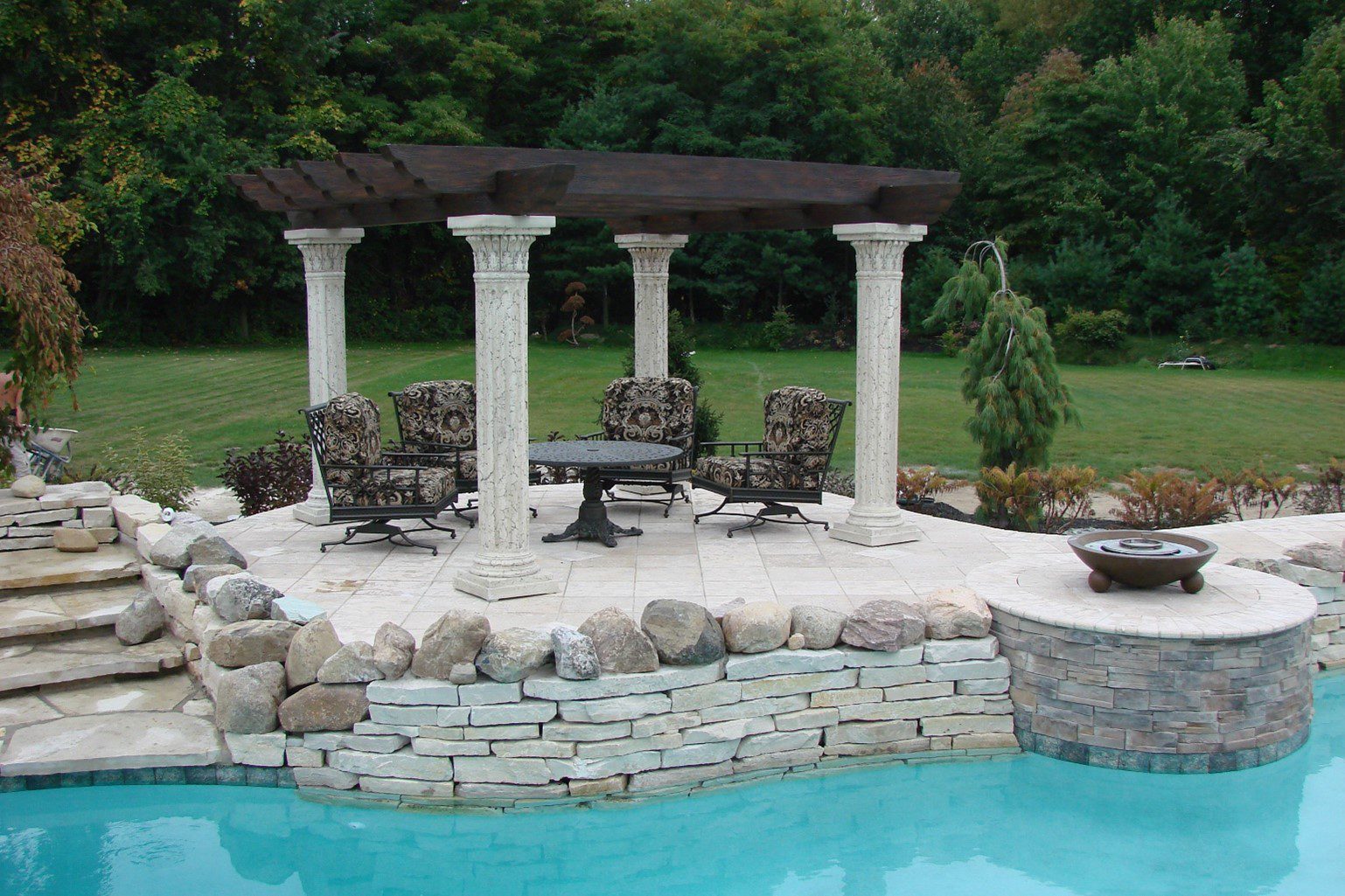 A pool with chairs and tables in it