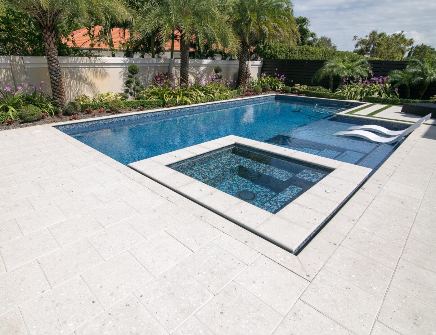 A pool with a jacuzzi in the middle of it