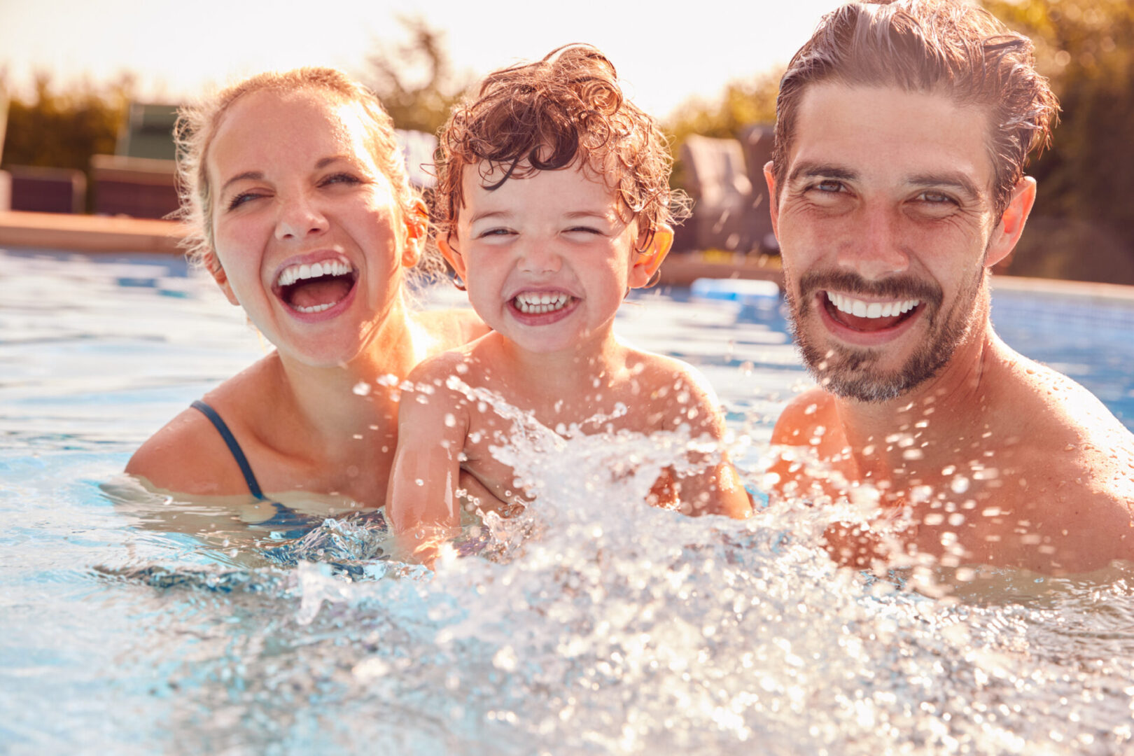 A family is swimming in the pool together.